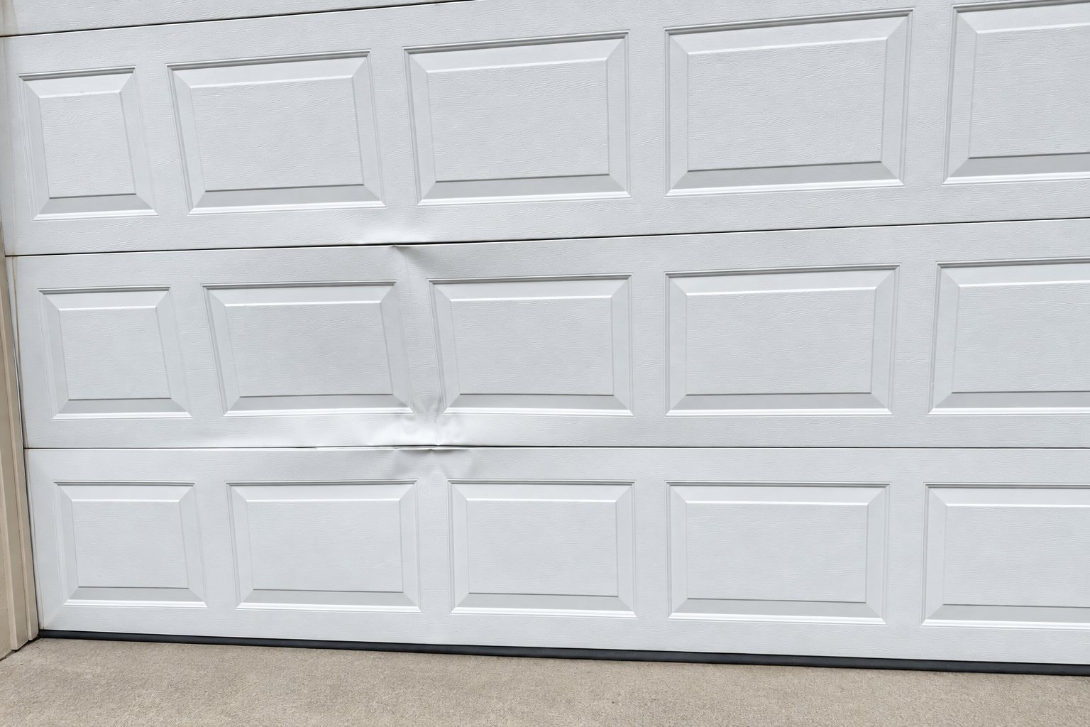Dented garage door panel